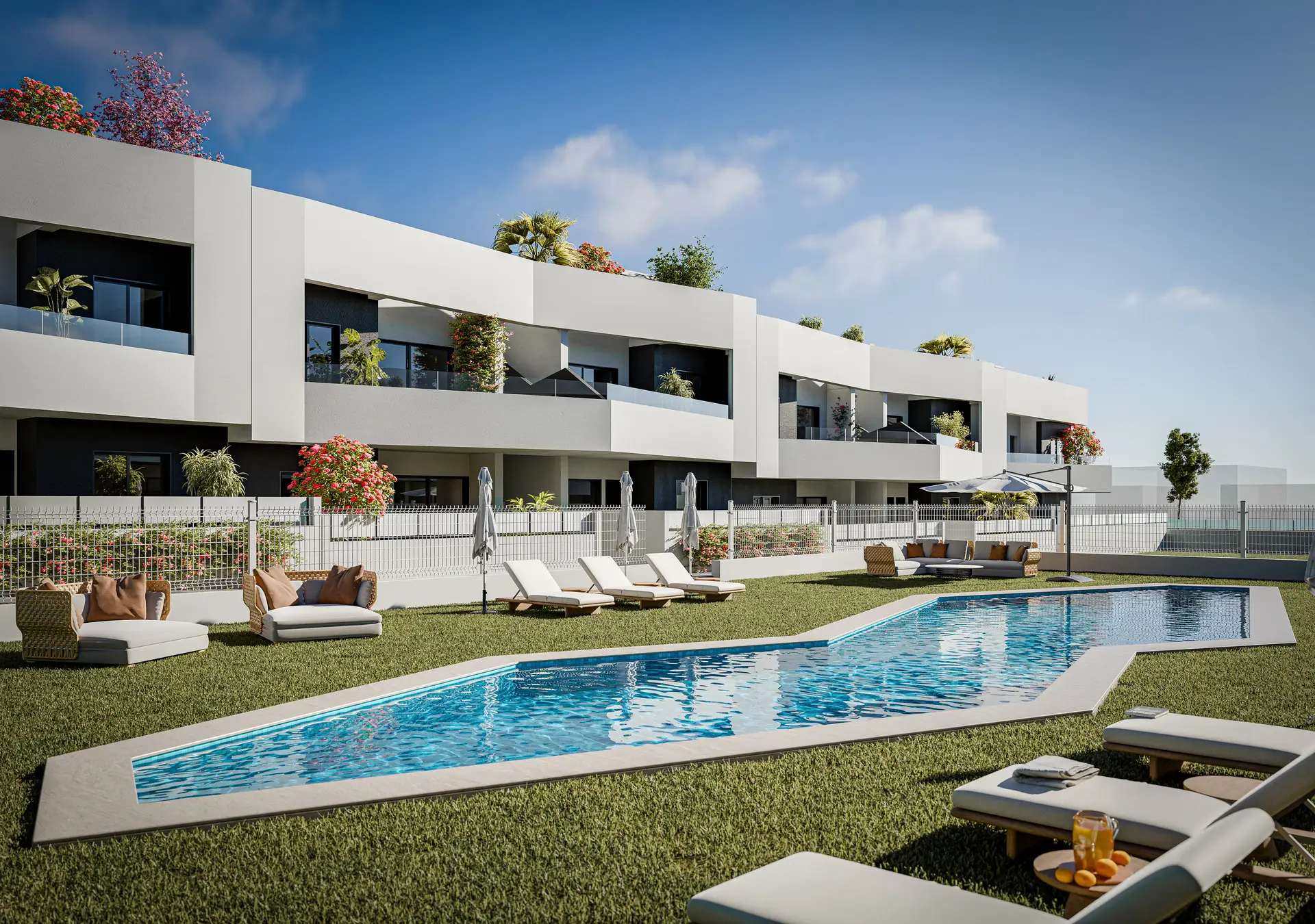 One of the two communal pools at Horizon Resort II, with lawn, sun loungers and the bungalow terraces behind